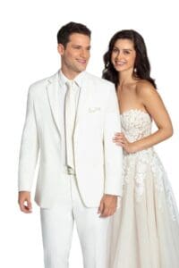 A man and woman in white dress posing for the camera.