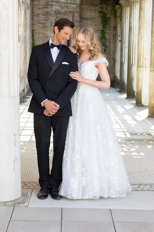 A man and woman in wedding dress posing for the camera.