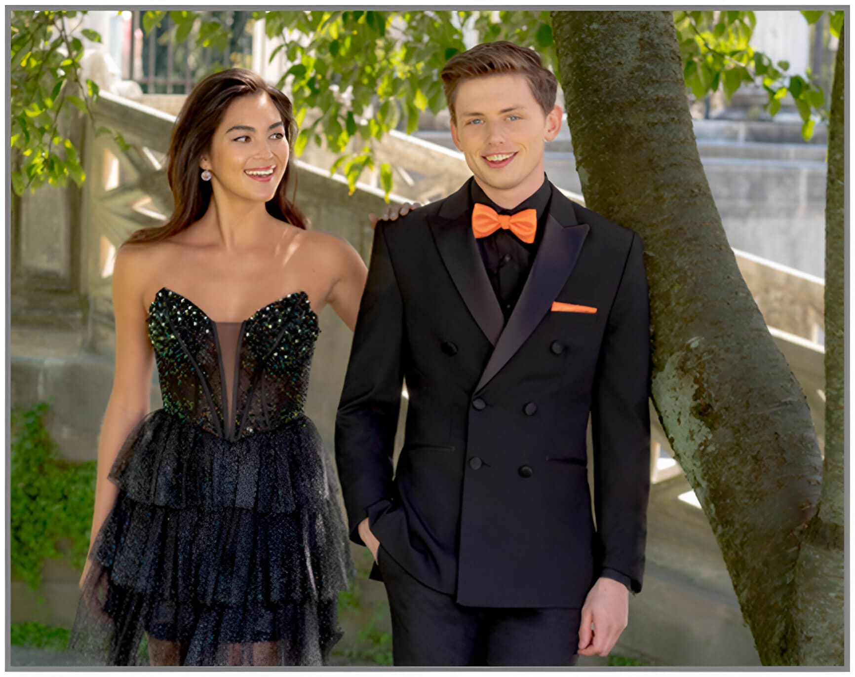 A man and woman in formal wear posing for the camera.