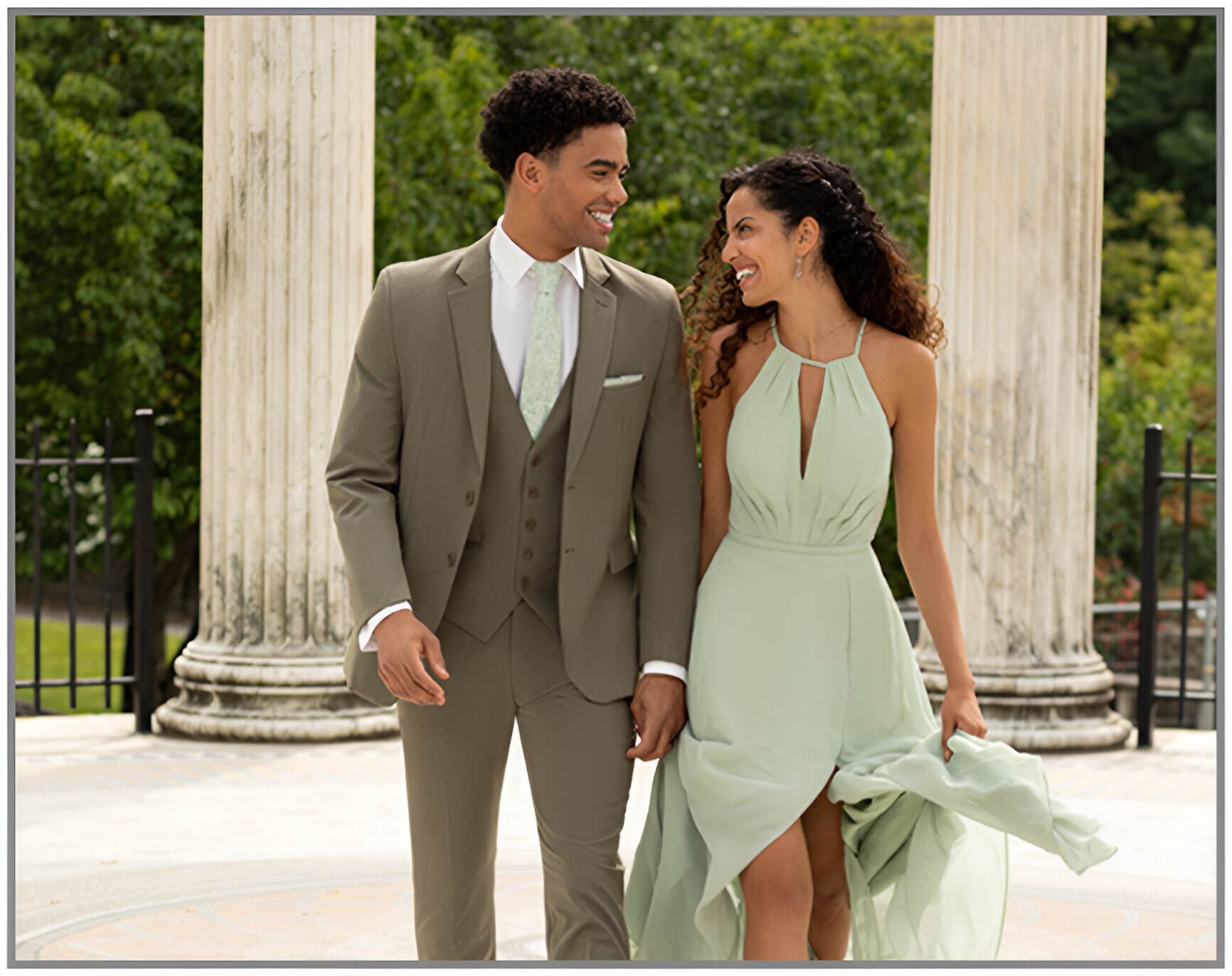 A man and woman in formal wear standing next to each other.